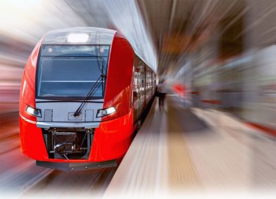 Modern high-speed train moves fast along the platform.