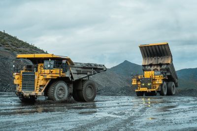Dump trucks unload ore