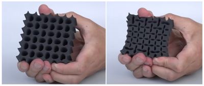 A hand squishing a squared structure filled with holes