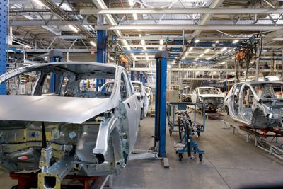 Cars being produced inside of a manufacture building