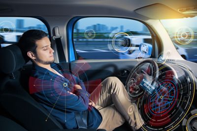 Man sleeping in a self driving car