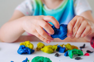 child playing with colorful play-dough
