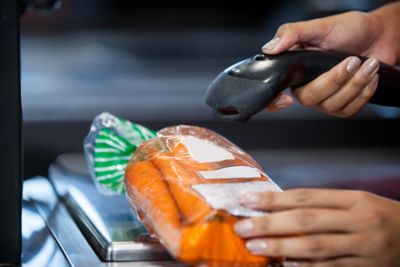 Barcode scanner scanning a bag of carrots