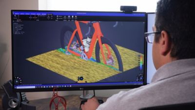 A man simulating a bike on a computer