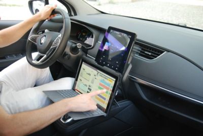 Person with computer in car