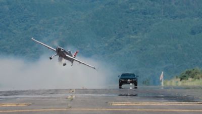 Plane flying next to car