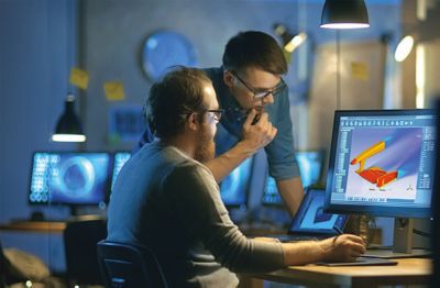 Two men studying a wing simulation 