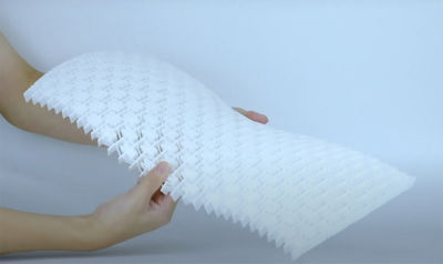 Honeycomb structure made out of perforated plastic being bent by someone