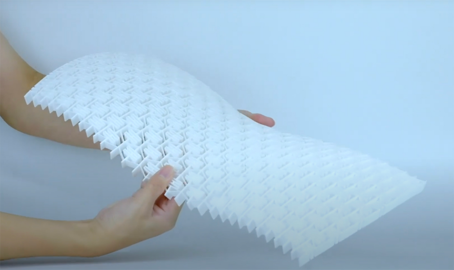 Honeycomb structure made out of perforated plastic being bent by someone