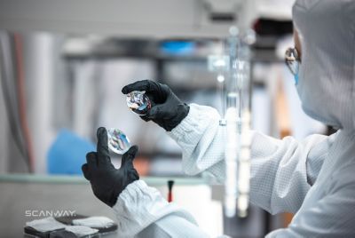 Scanway employee comparing optics