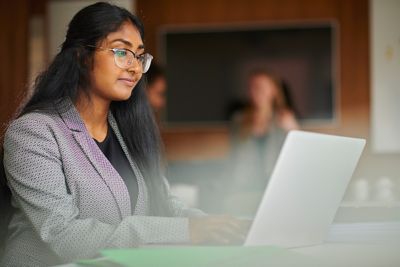 Student on laptop in a library