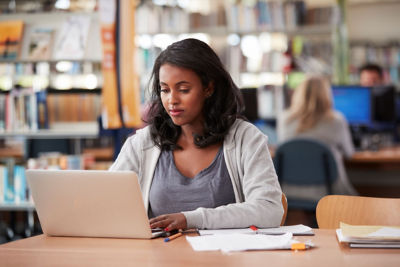 Student on laptop in a library