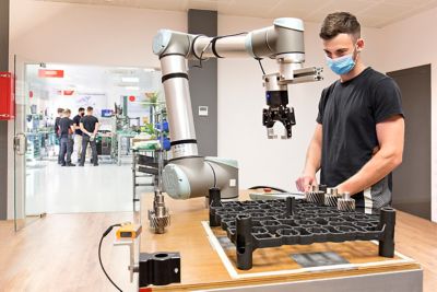 Man operating robot arm